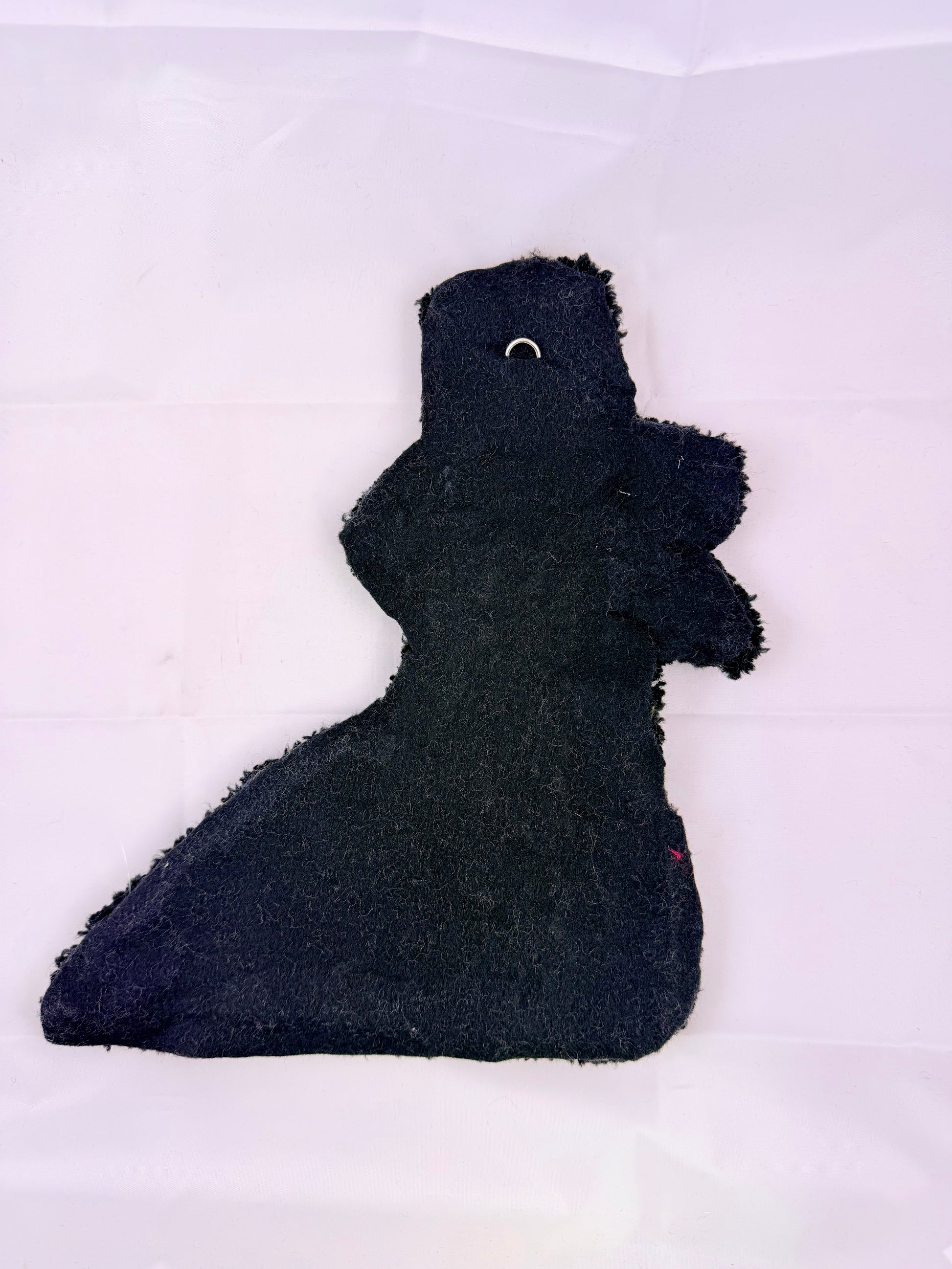 Black tufted rug back on a white background