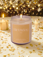 Candle labeled 'Birthday Cake' with gold confetti and lights in the background