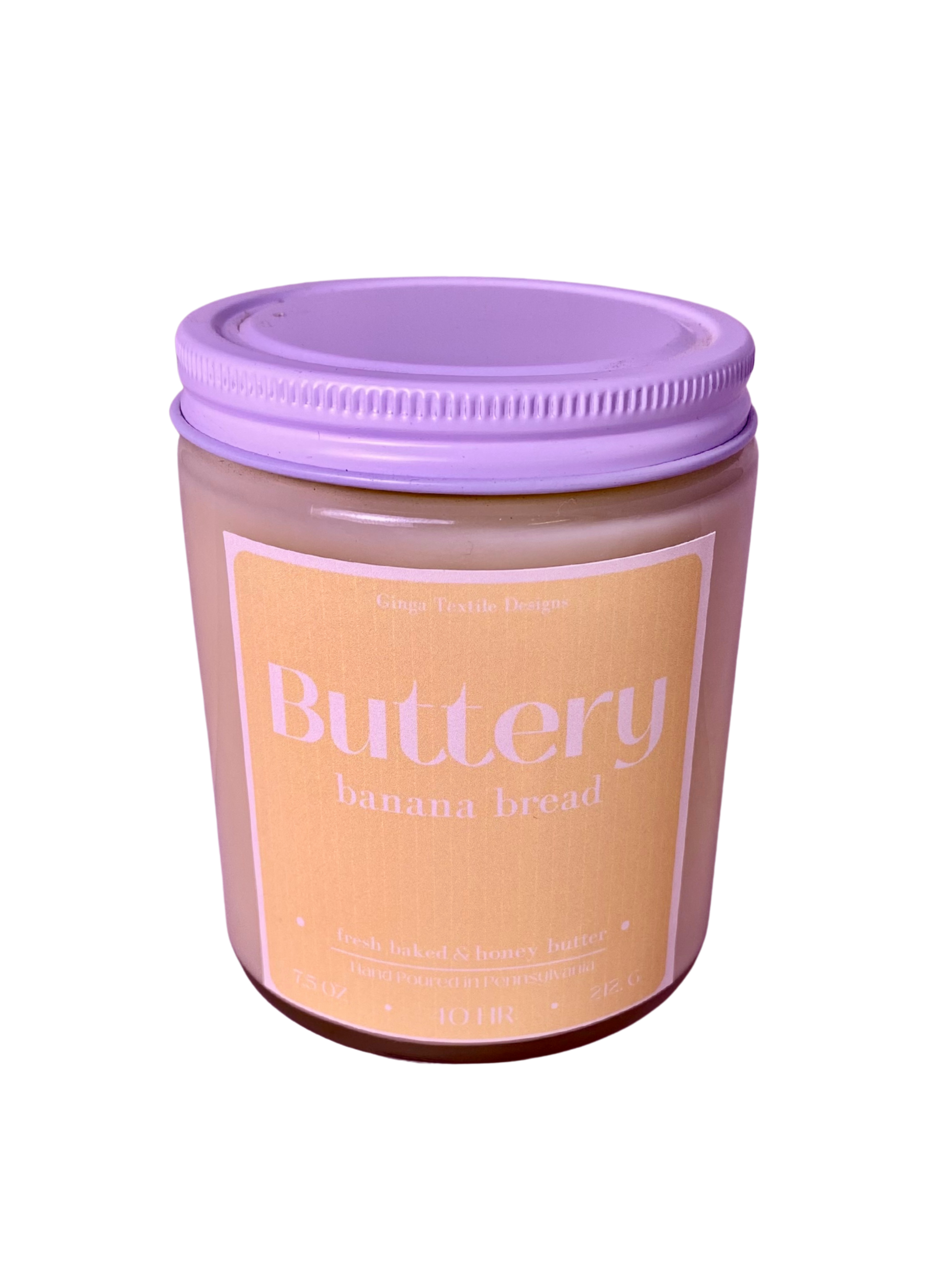 Jar of 'Buttery Banana Bread' scented candle with a white lid on a white background