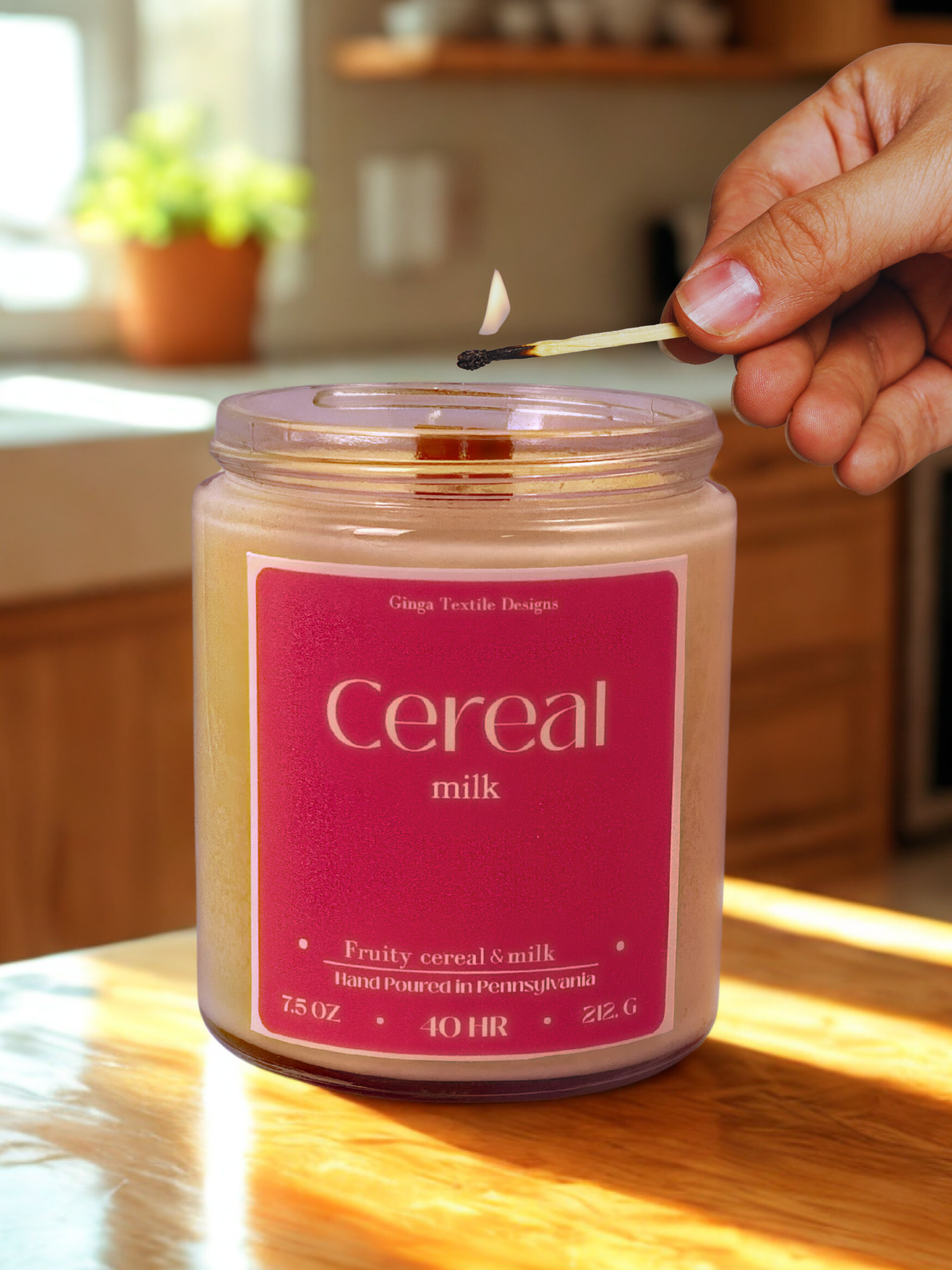 Candle labeled 'Cereal milk' being lit with a match in a kitchen setting.