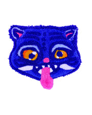 Tufted rug of a cat face with colorful eyes and pink tongue on a light purple background