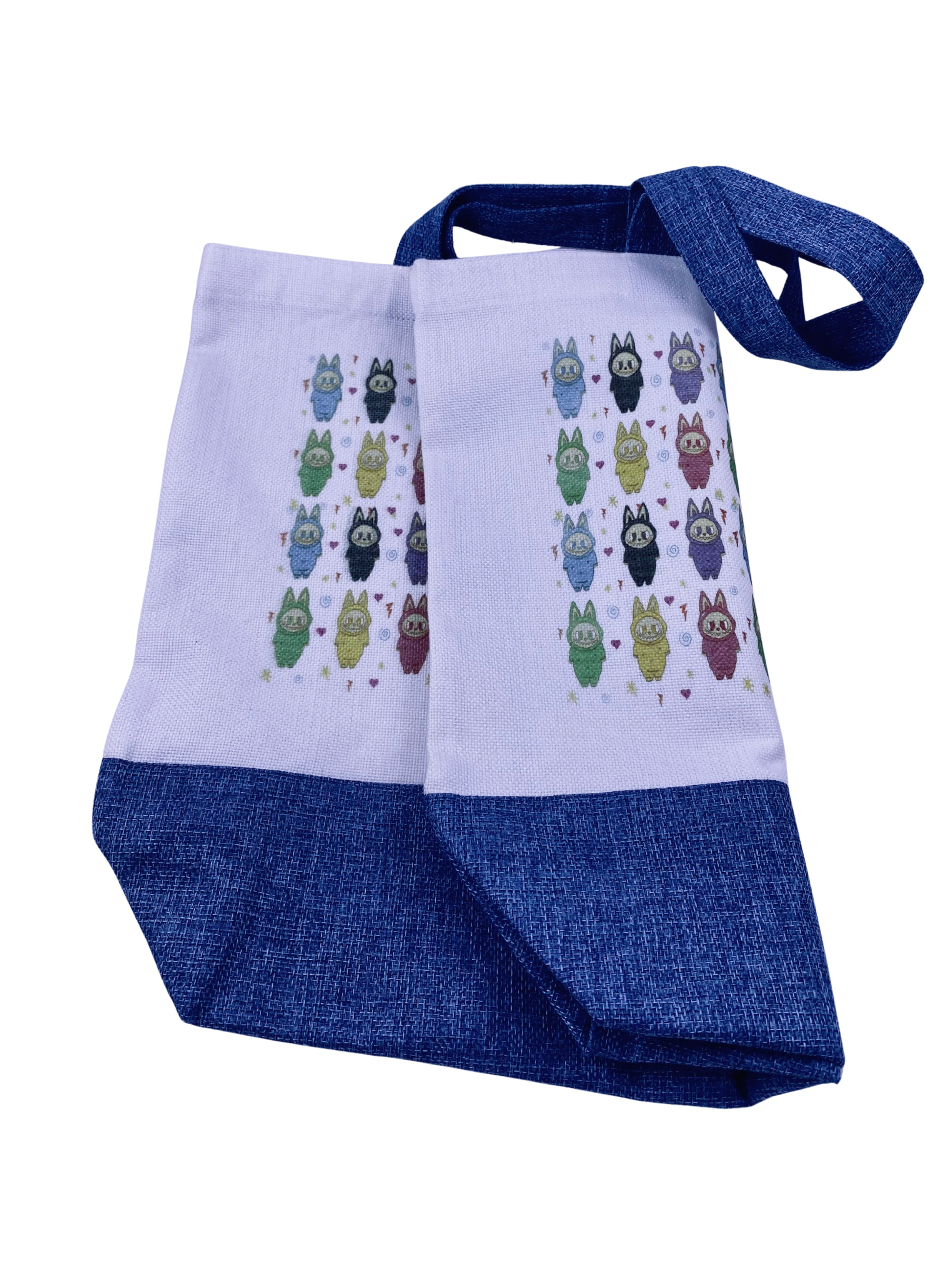 partially folded two toned colored canvas tote bag showing double sided character print.