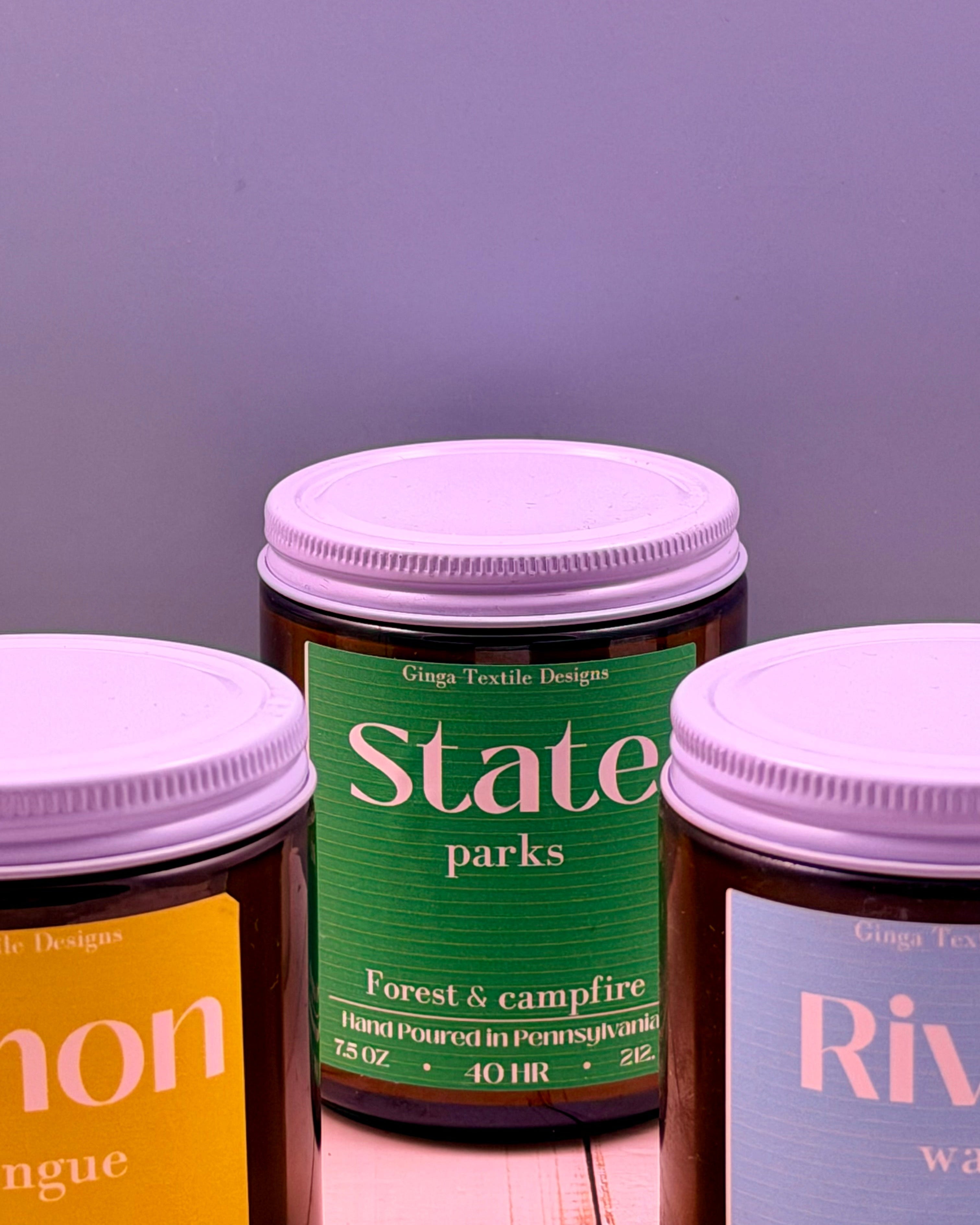 Three jars with purple lids on a wooden surface against a gray background