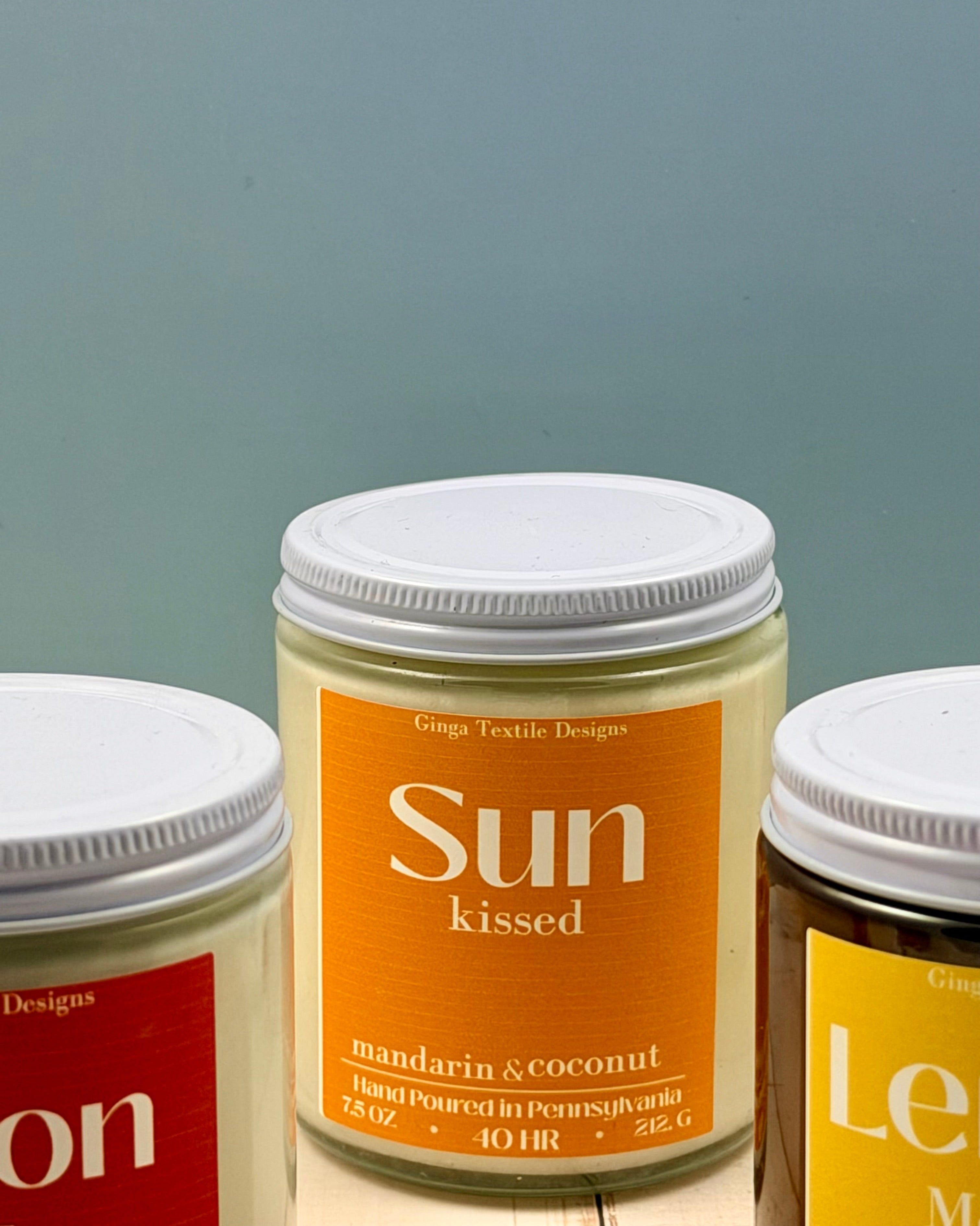 Three jars of different scents on a gray background