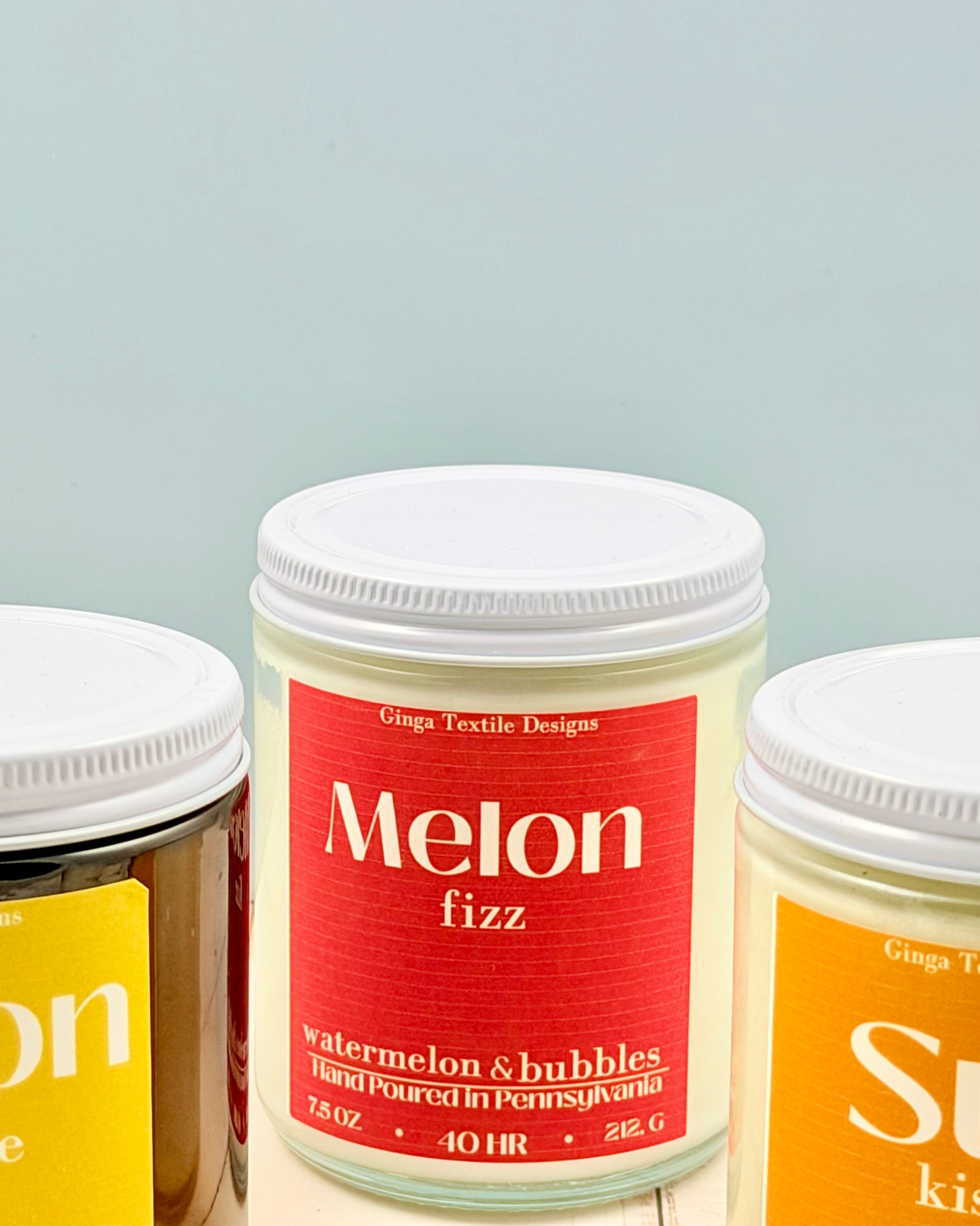Three containers with lids, one labeled 'Melon fizz' on a light gray background