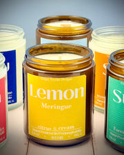 Jar candles with colorful labels on a wooden surface