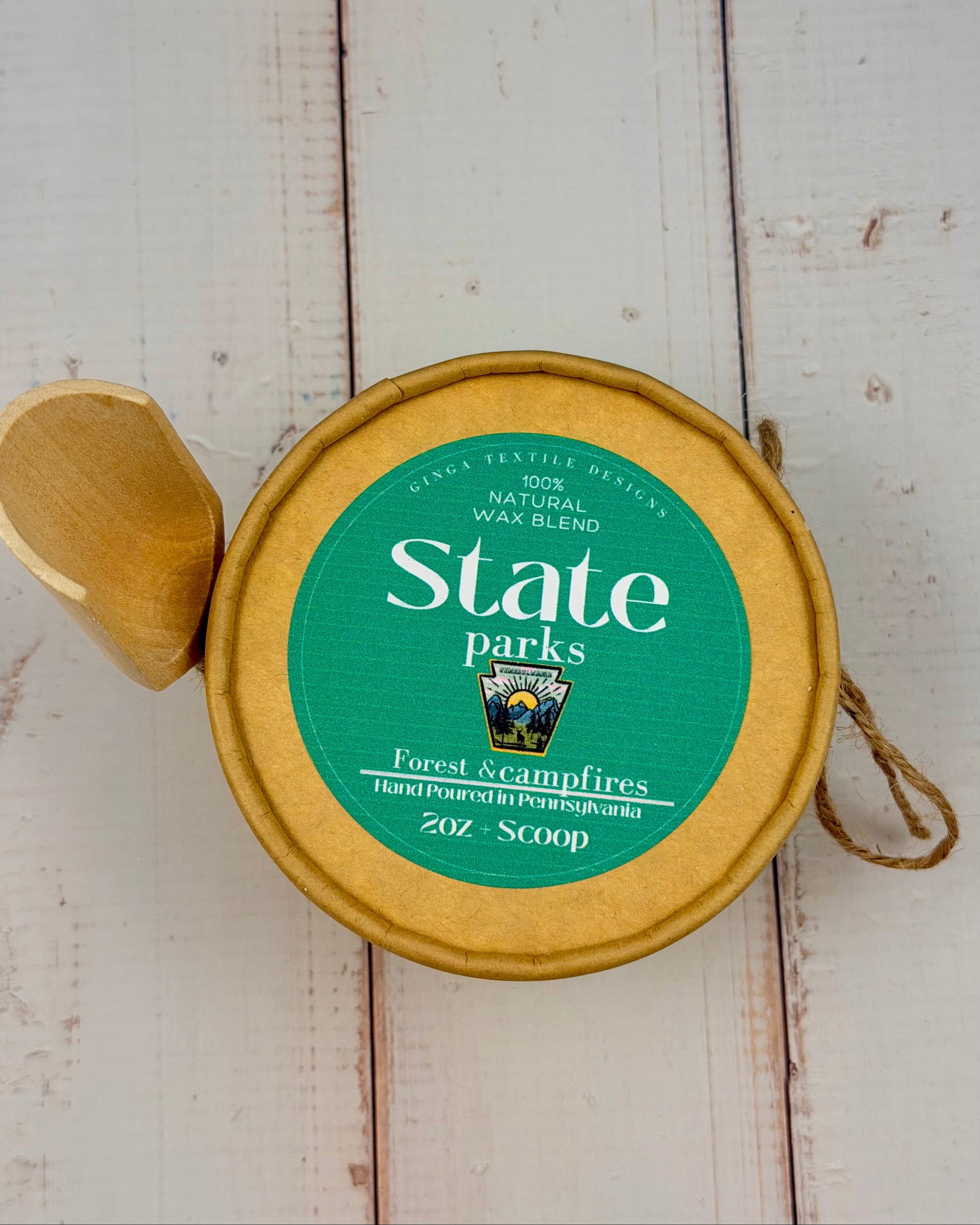 State Parks wax blend container with green label on a wooden surface