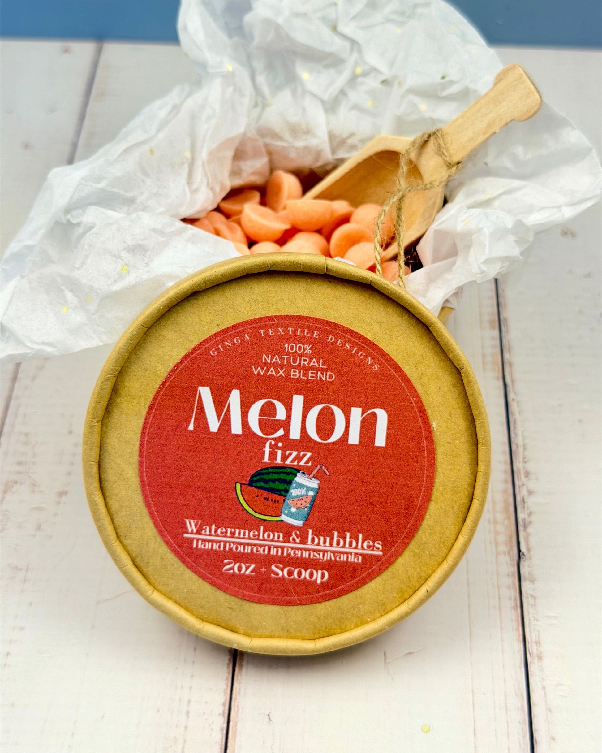 Melon fizz wax blend container with a scoop of wax on a white surface
