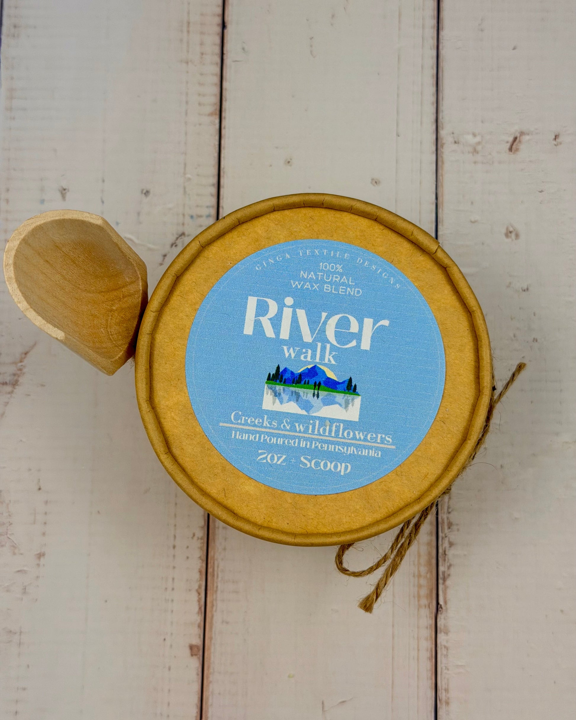 Round container with a blue label on a light wooden surface