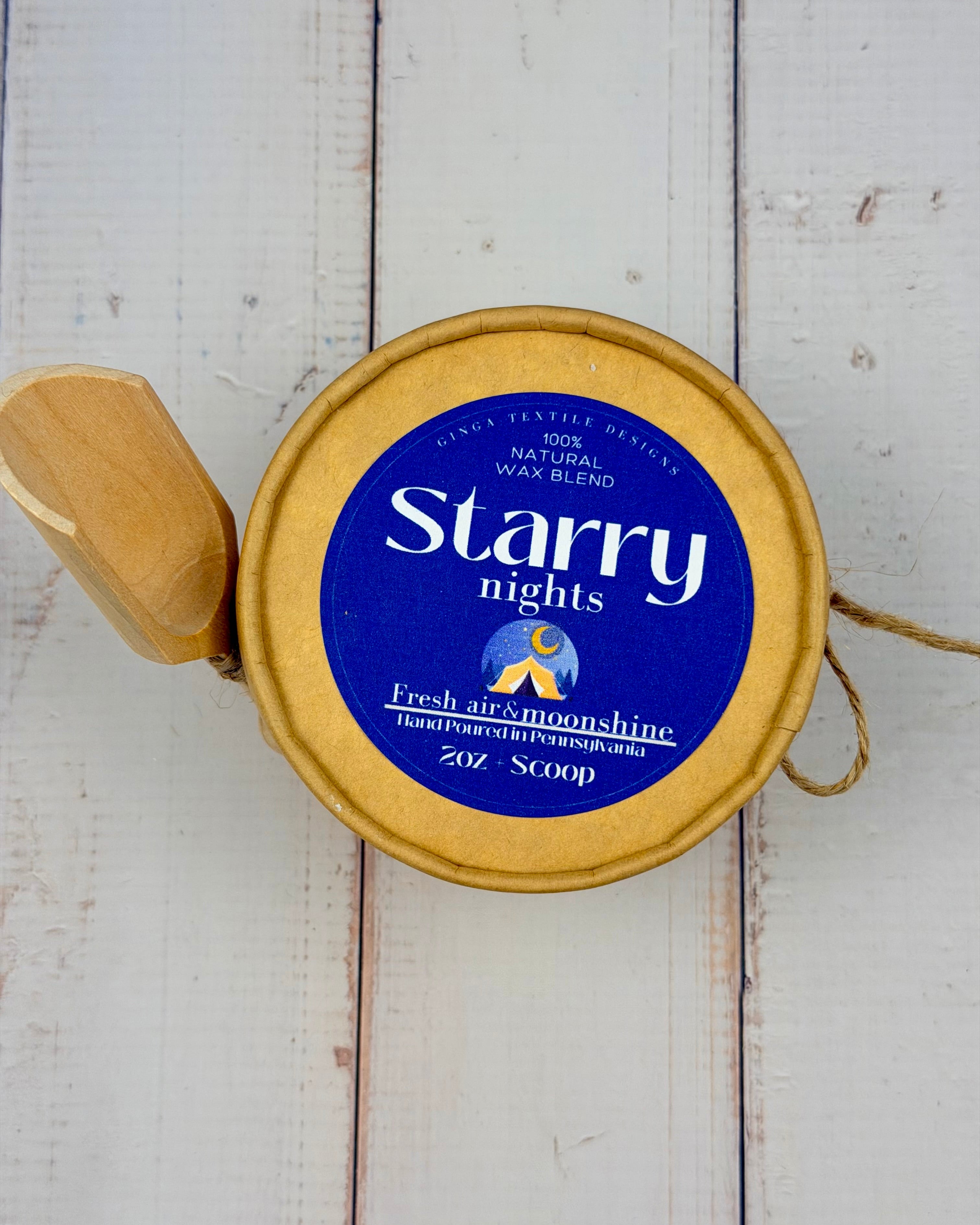 Starry Nights wax melt container on a wooden surface