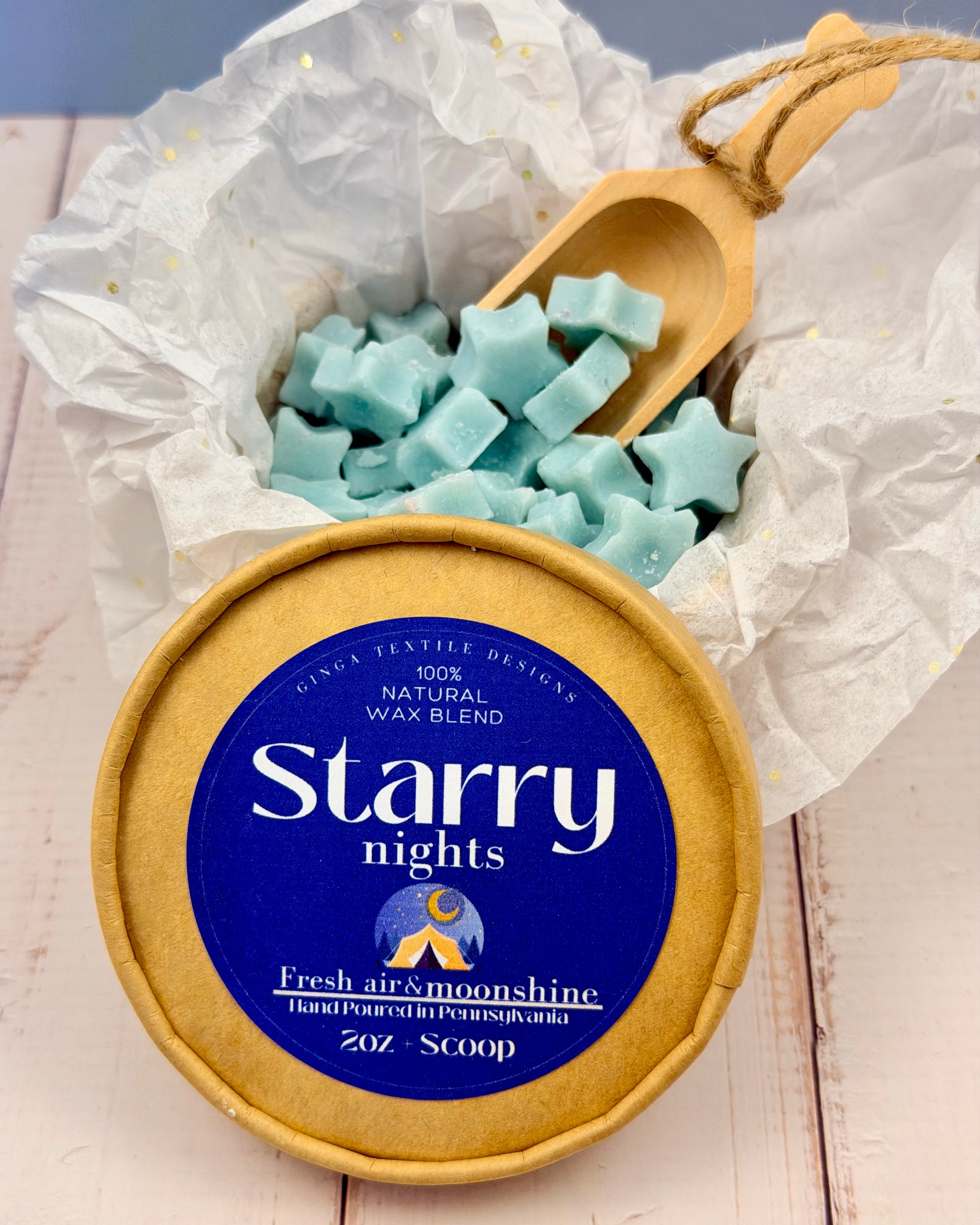 Jar of 'Starry Nights' wax melts with a wooden scoop on a white surface.