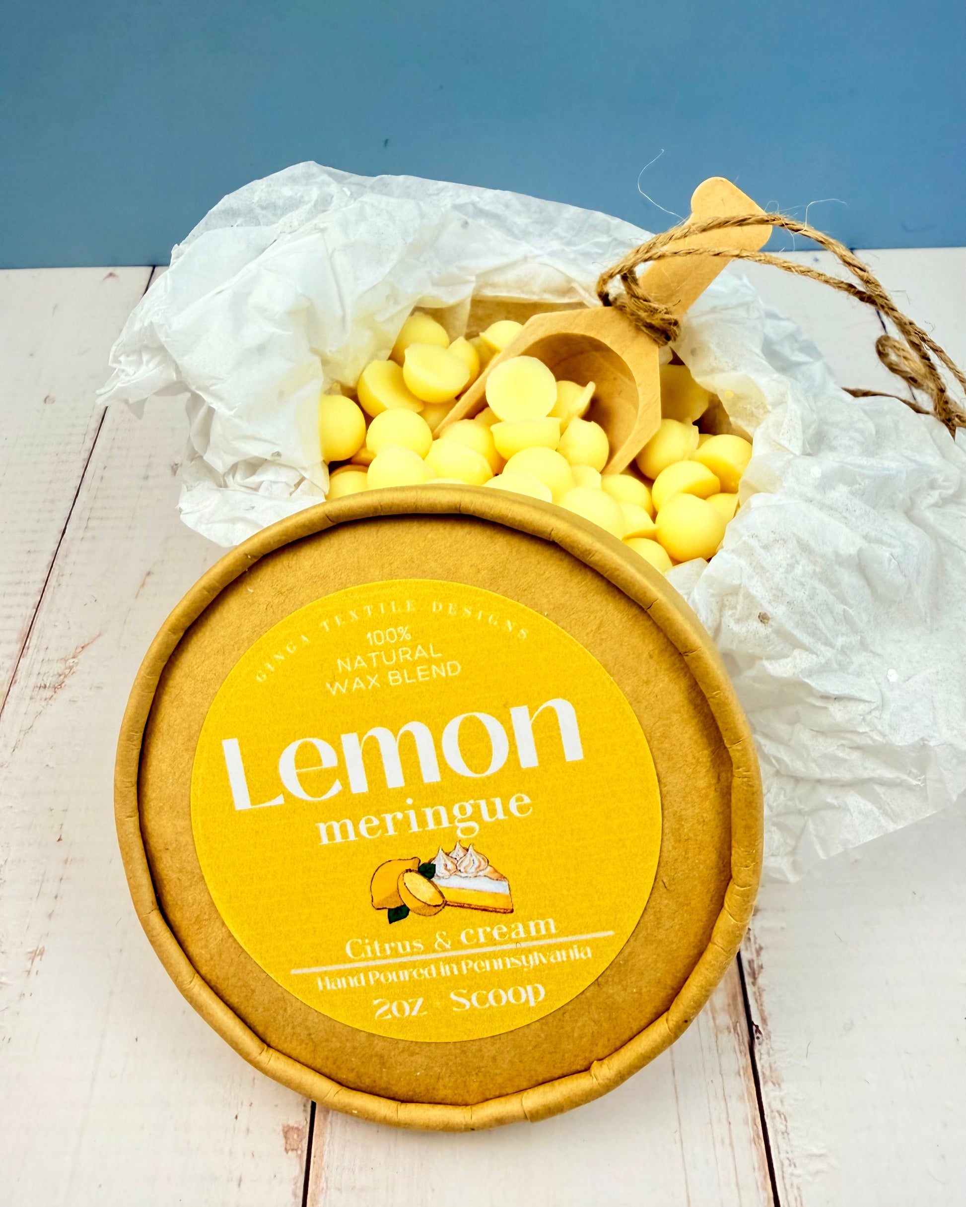  Lemon Meringue wax melts on a wooden surface with a blue background