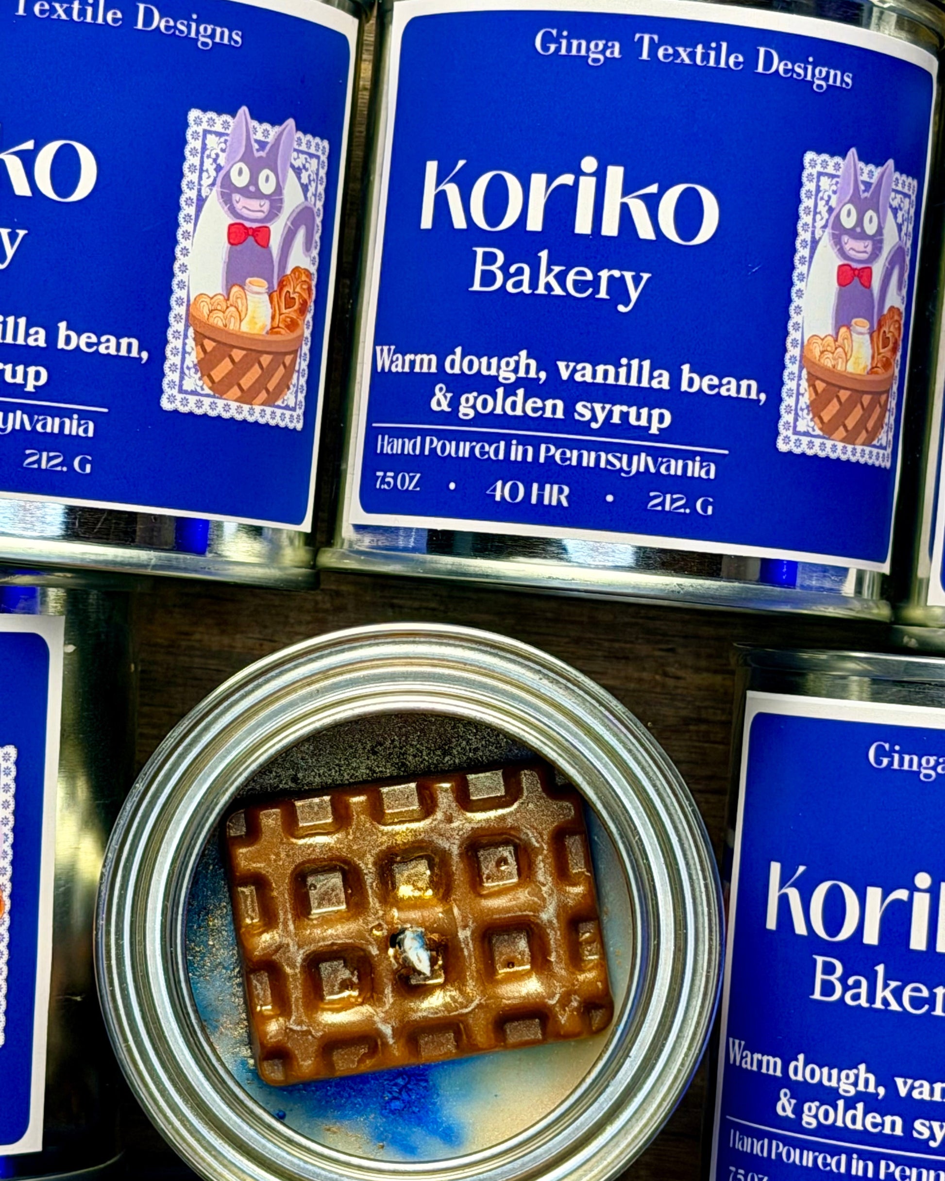 Koriko Bakery can with a waffle inside, surrounded by other Koriko Bakery cans.