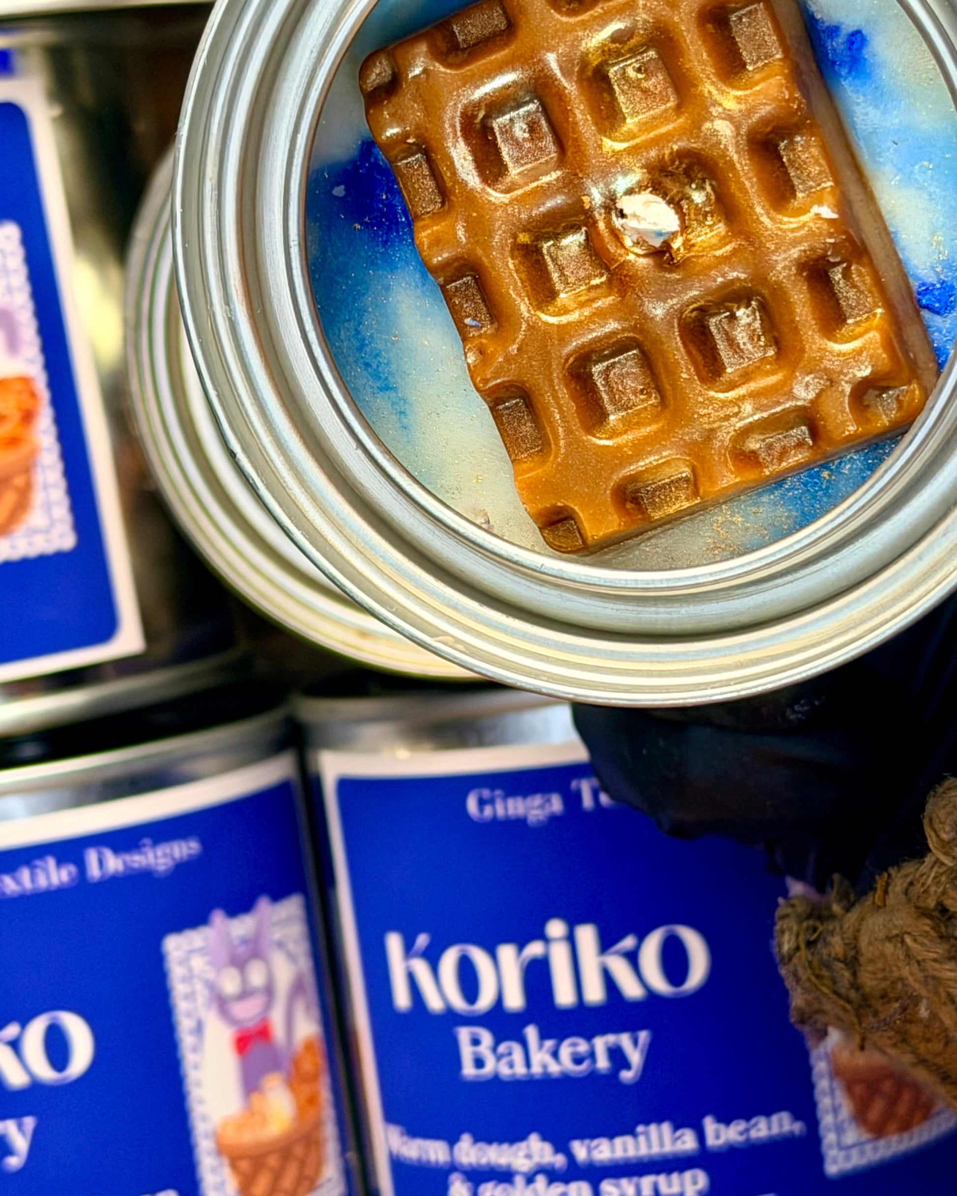 Koriko Bakery candle with waffle wax embeds inside a can with visible branding