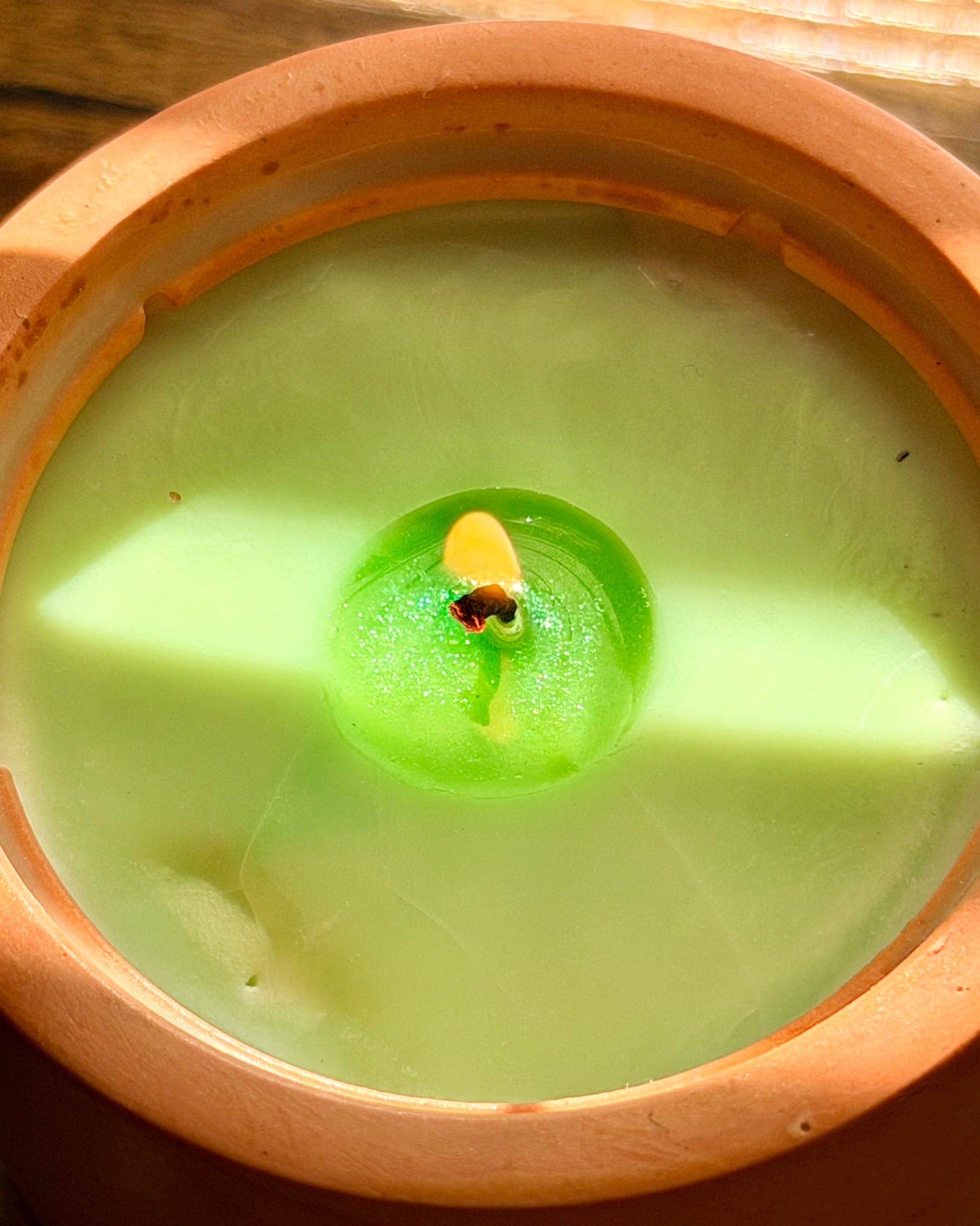 Green candle in a concrete container