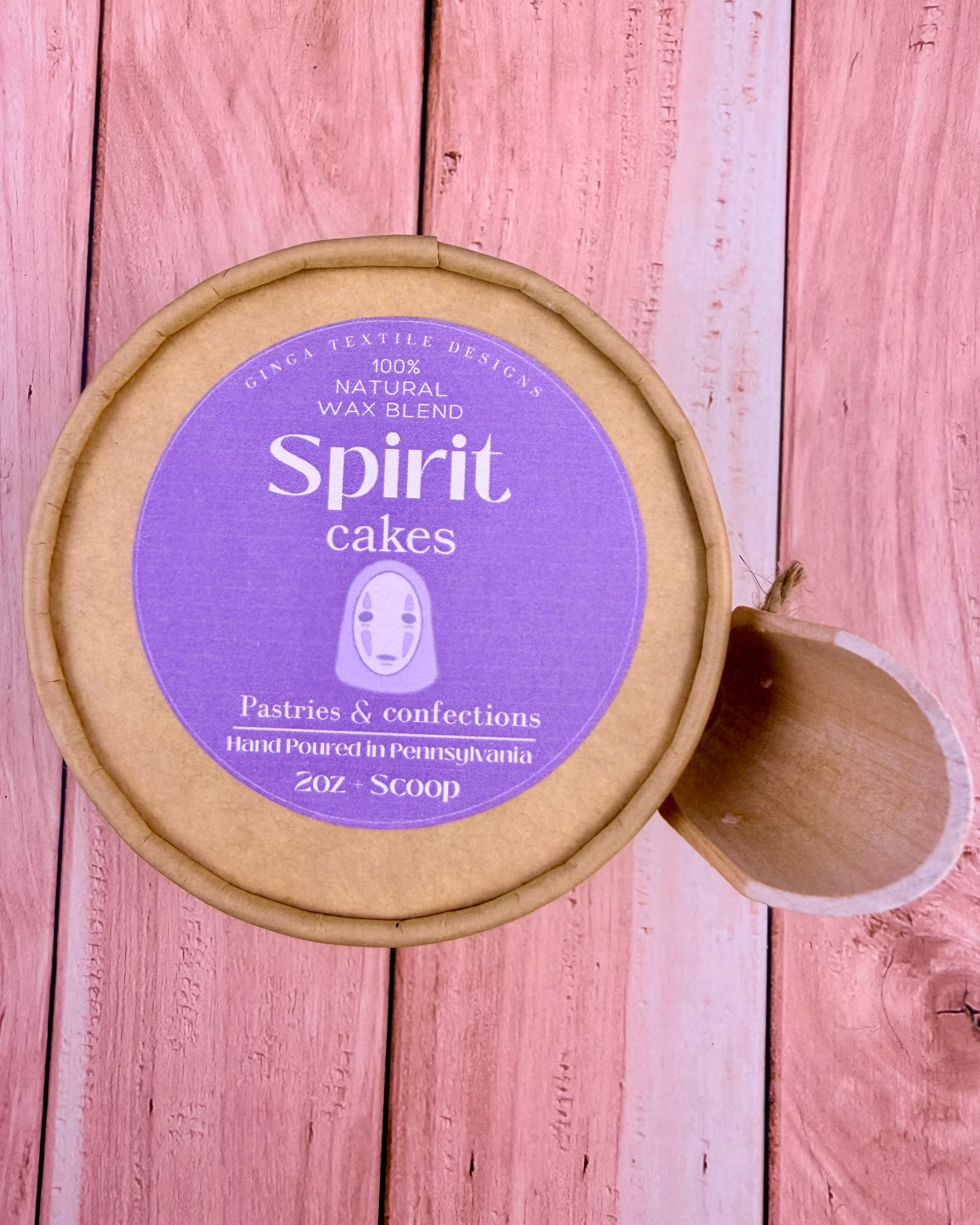 Container of 'Spirit Cakes' wax melts on a wooden surface