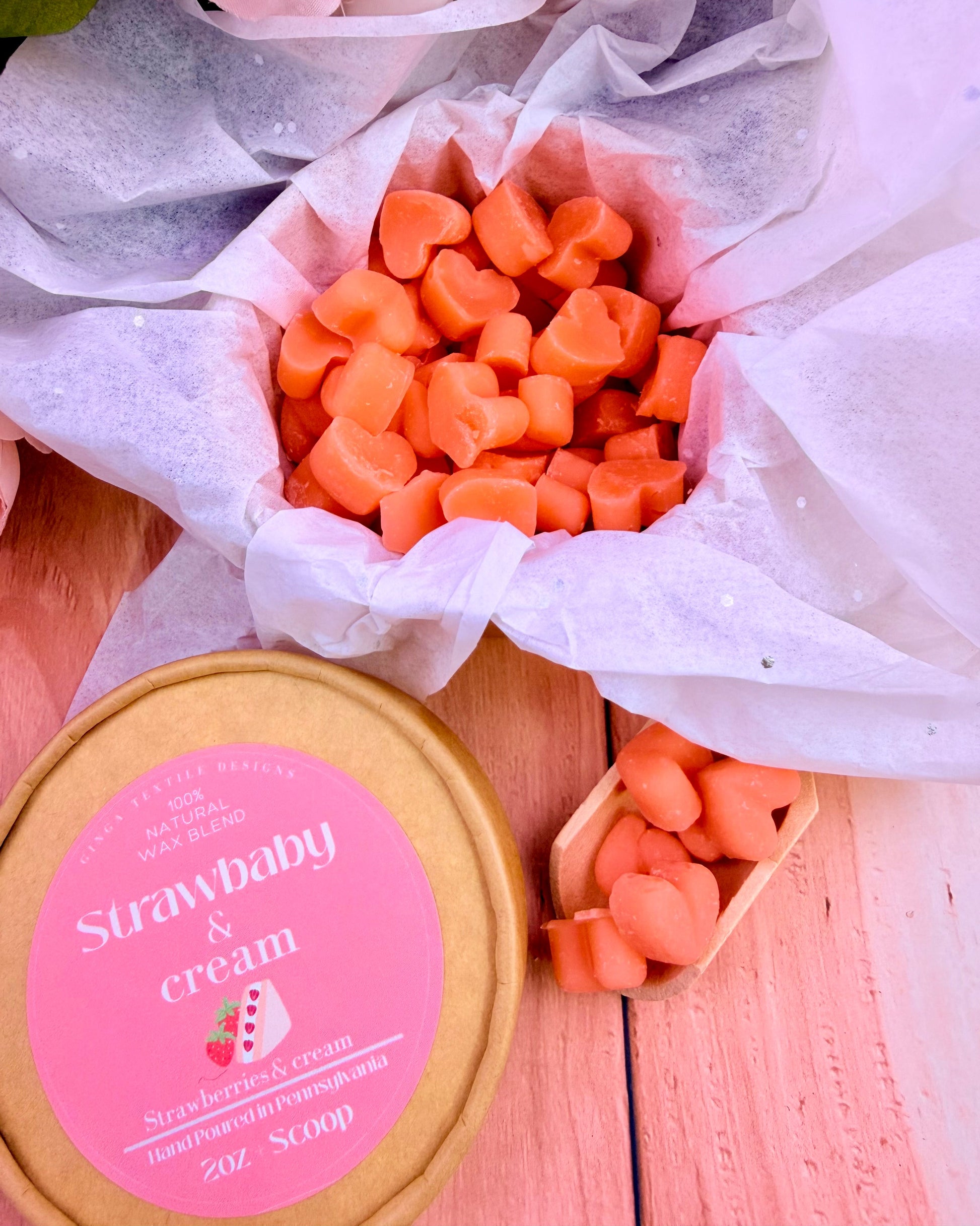 Strawberry & cream themed wax melts and container on a wooden surface