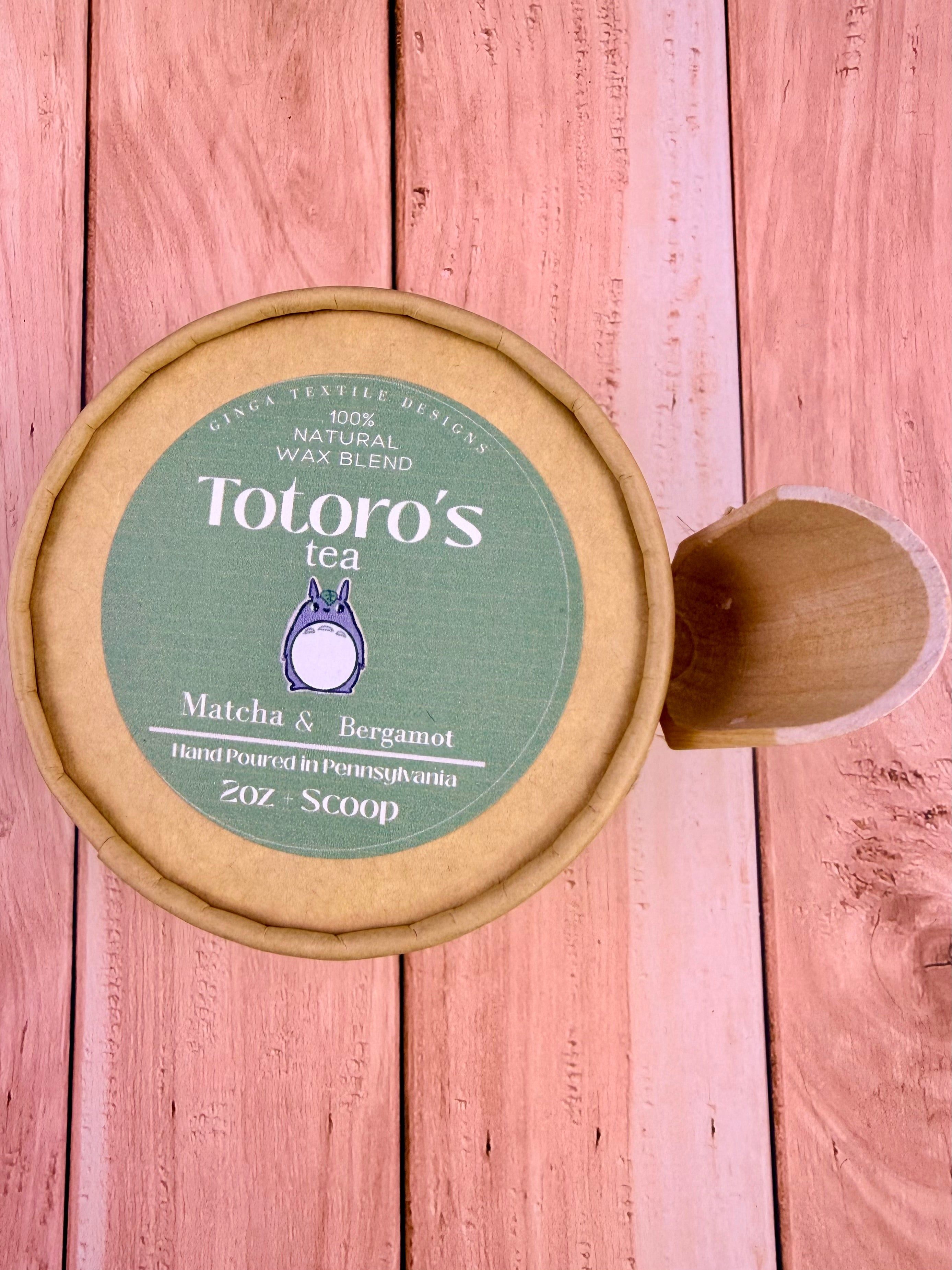 Totoro's Tea container with a wooden lid on a wooden surface