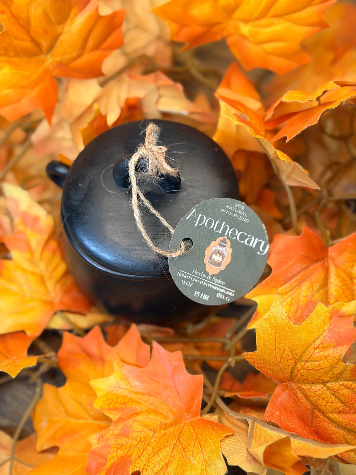Apothecary black Hydrostone cauldron vessel with green pillar candle and lid