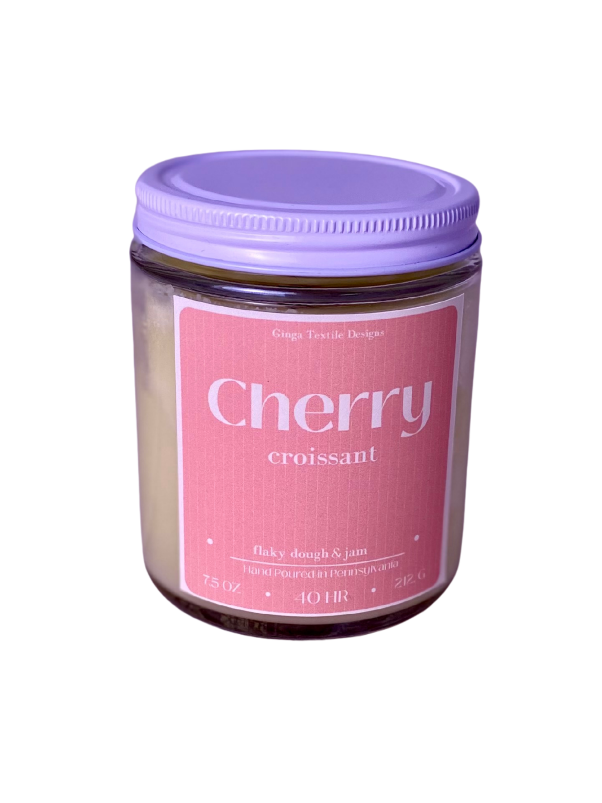 glass jar of 'Cherry Croissant' scented candle with a pink label and white lid on a white background