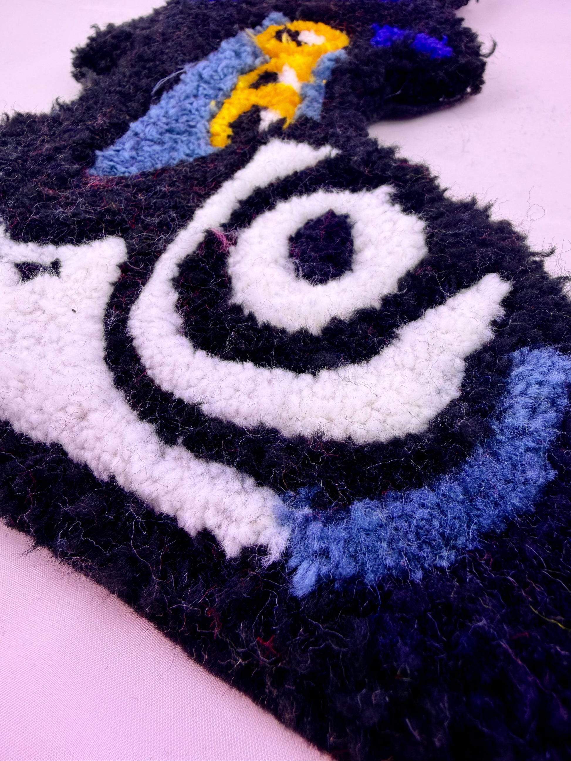 Close-up of a textured surface with a spiral pattern and cartoon character.