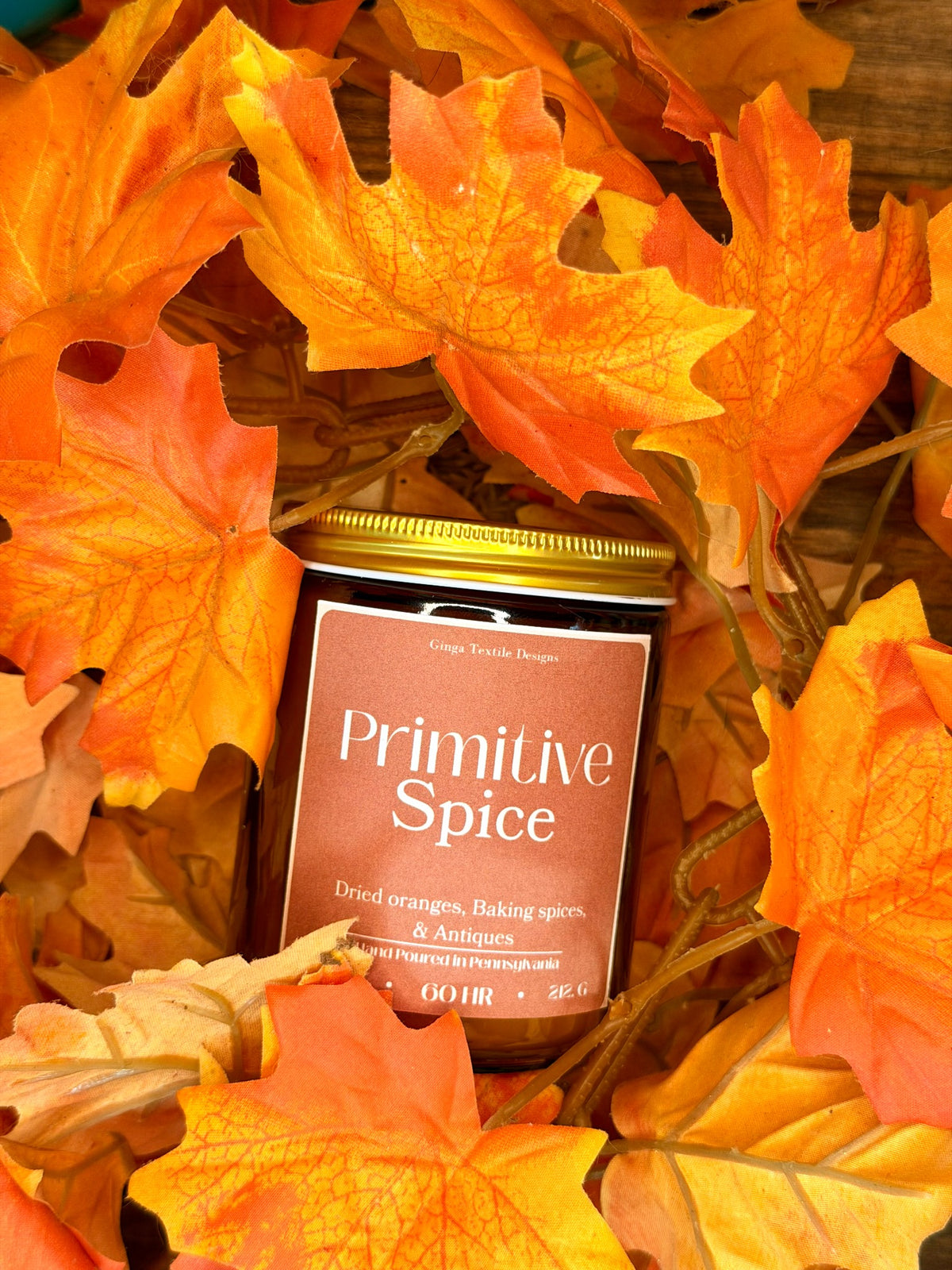 Primitive Spice candle styled in a warm autumn flat lay